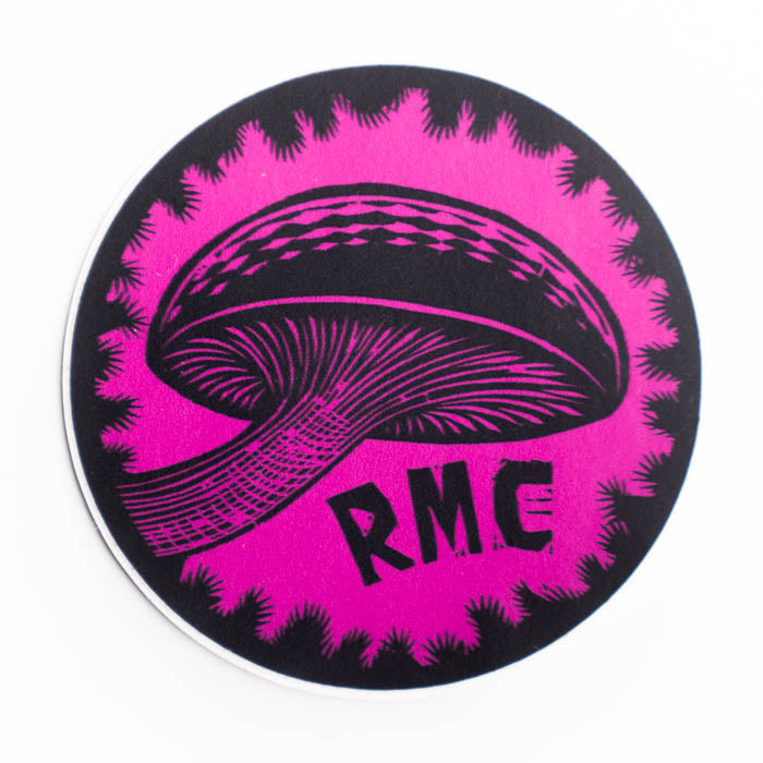 Round sticker with black graphic and 'RMC' text on a pink background