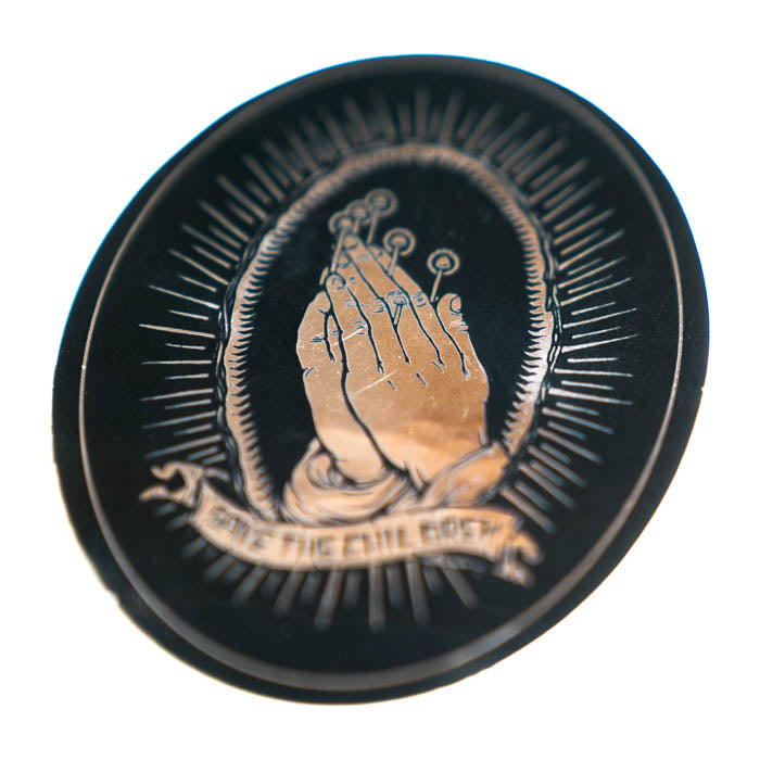 Circular sticker with praying hands and text 'Save the Children' on a black background