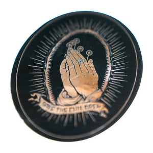 Circular sticker with praying hands and text 'Save the Children' on a black background