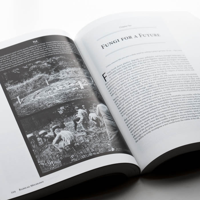 Open book with text and black and white photo on a white background