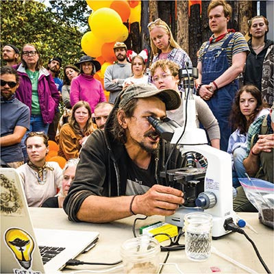 Teacher at microscope